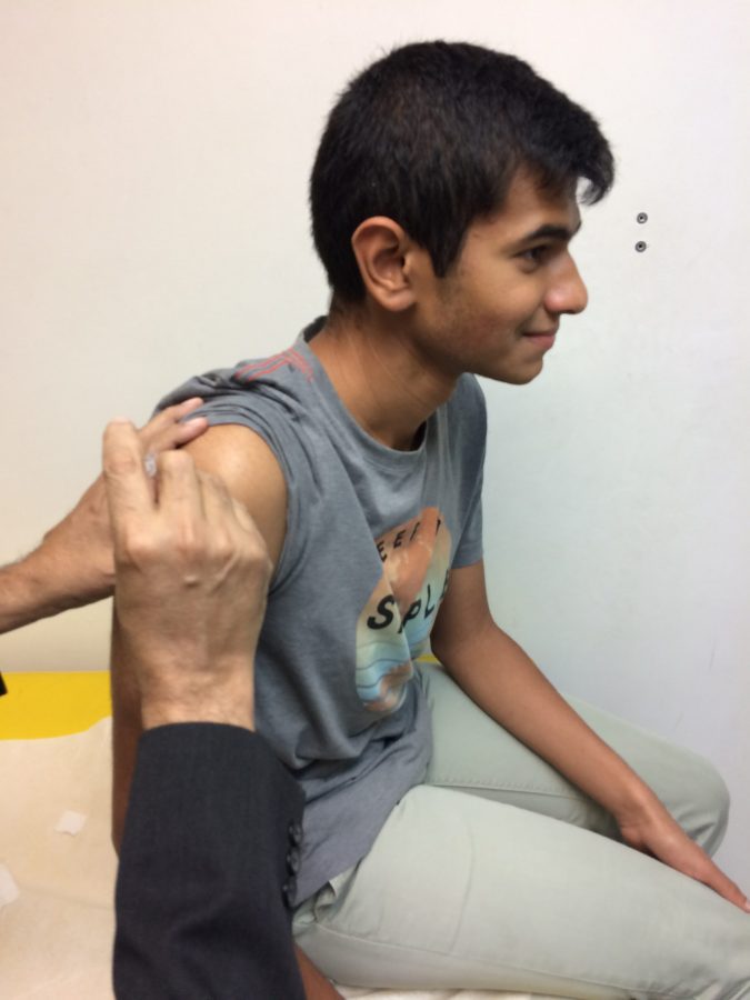 Shots for Safety—Senior Shrinath Viswanathan is vaccinated for the meningitis virus at his doctor’s office. Photo reproduced by permission of Shrinath Viswanathan