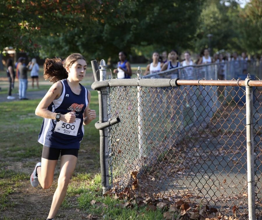 Star runner Isabella Izzy Spagnoli races-by during her cross country meet.