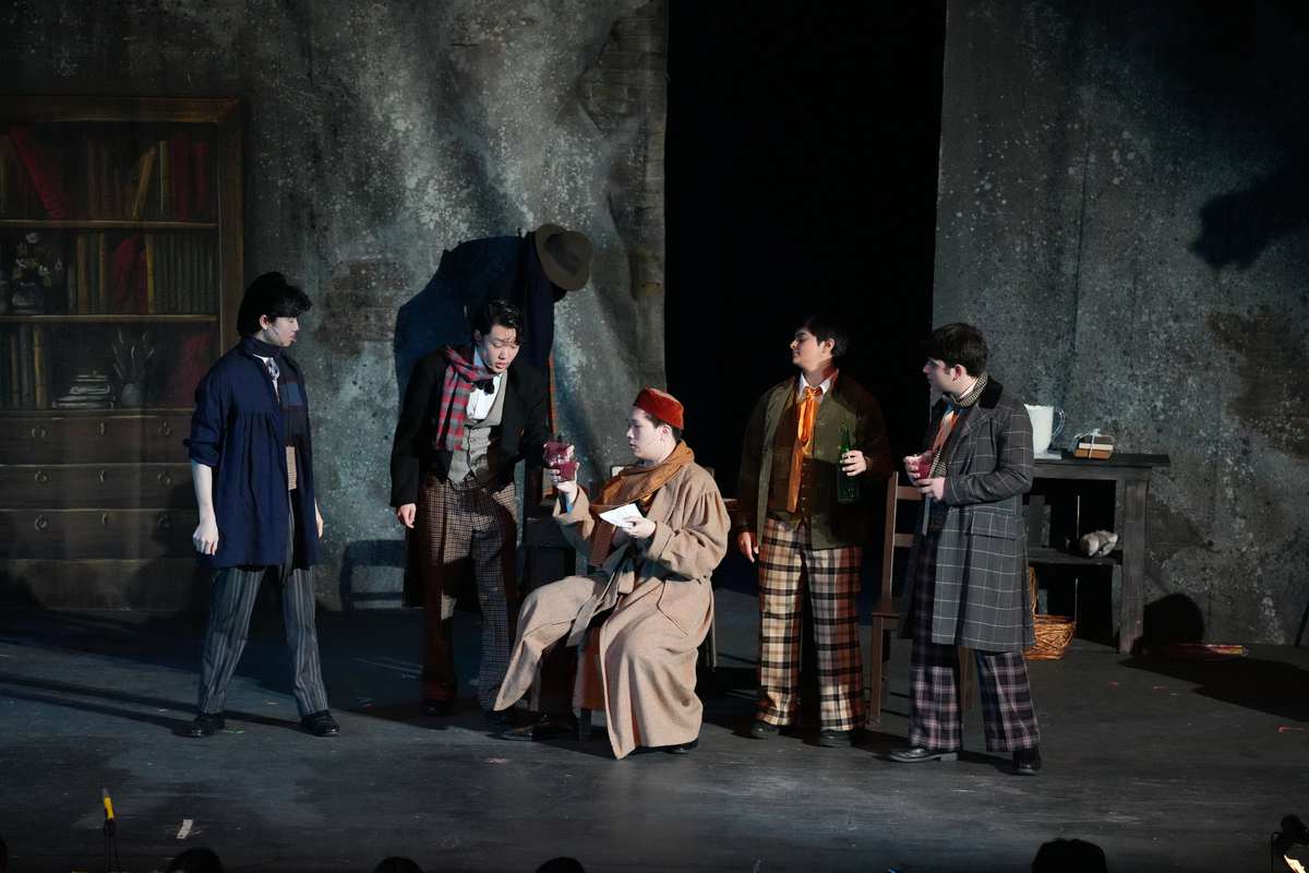 Wine as Payment for the Rent—In Act One of La Bohème, Marcello (Chris Fukuda), Rodolfo (Nathan Park), Schaunard (Nandini Khaneja), and Colline (David Kagan) comedically convince their landlord, Benoît (Ethan Lin), to waive their rent. After offering him multiple glasses of wine and disposing of the rent statement, the roommates celebrated, prompting laughter from the audience. 