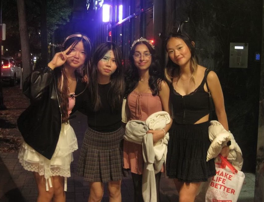 An immortal image—(From the left) Isabell Dong, Janice Zhang, Riya Thawani, and Christa Xu capture a memorable Halloween night on a digital camera.