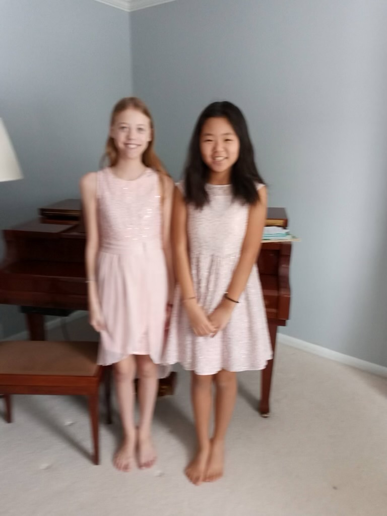 Beginning as Strangers, Ending as Sisters—Eleven-year-old Zoe Sun and her host sister Andréa Rivet have a special “twin” moment in matching pink dresses as they pose for a picture. While initially apprehensive, the two bonded as they spent more time together. As friendship grew into deep emotional connection, Zoe and Andréa became inseparable as unofficial “twin” sisters. 