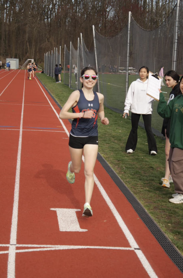 Smile for the camera!" — Izzy as she strolls right through the finish line.