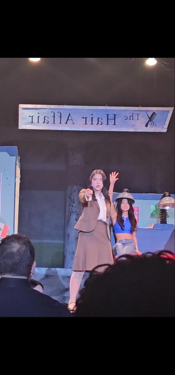 Lights, Camera, Action!: Skylar Lu, in character as Vivian, sings Legally Blonde (Remix) at Theater South’s production of Legally Blonde. Despite initial anxiety, Skylar quickly immerses herself in the performance and takes the stage by storm.