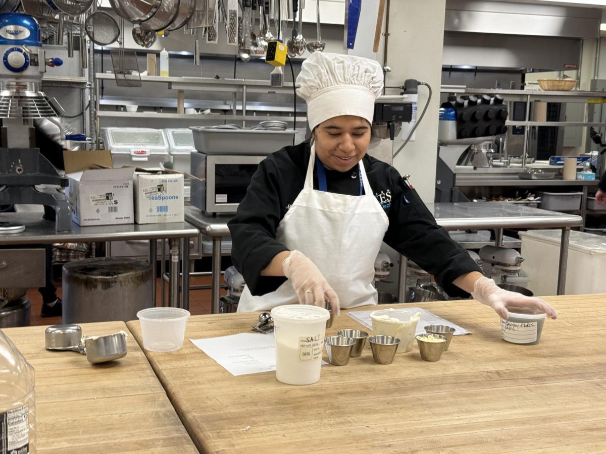 Doughing It Right — Junior Maite Ariza Salamanca measures ingredients with precision as part of her culinary training. 
